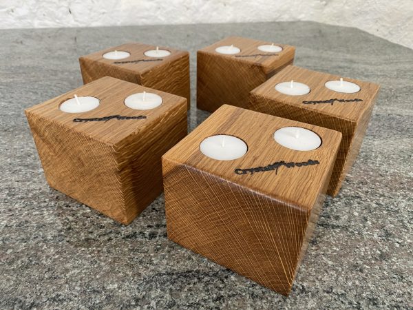 Close up end grain view of these Set of 5 Oak Cubed Block Tea-Light Candle Holders, with two tea lights in each, finished in oil, created by Crystal Woods, branded with their logo stamp