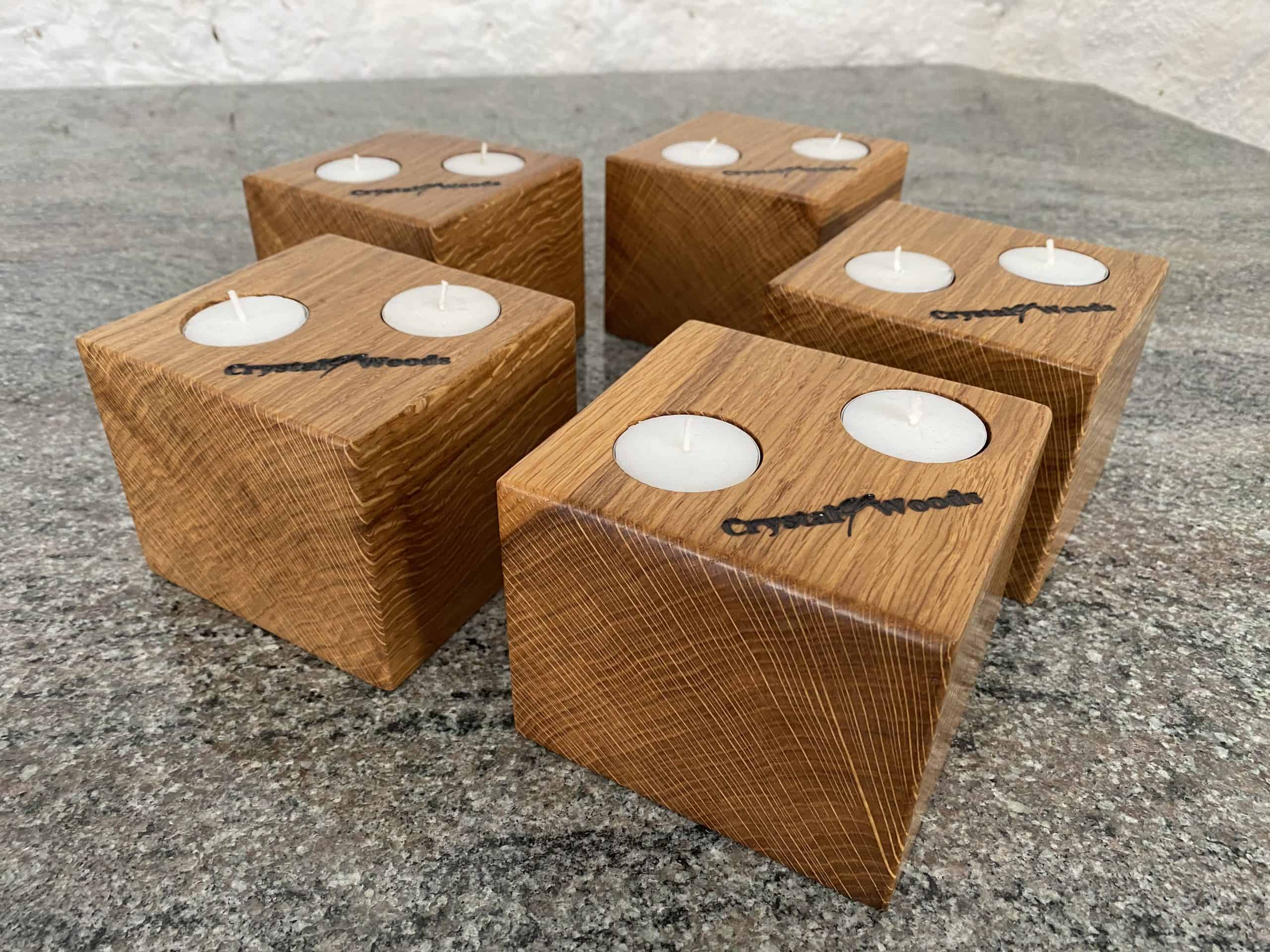 Set of 5 Oak Cubed Block Tea-Light Candle Holders 4 Close up end grain view of these Set of 5 Oak Cubed Block Tea-Light Candle Holders, with two tea lights in each, finished in oil, created by Crystal Woods, branded with their logo stamp