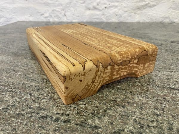 Close up angle view of this Large Round Top English Spalted Beech Chopping Board, handcrafted by Crystal Woods, finished in food safe oil, locally sourced wood in Devon