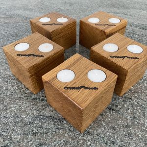 Over view of this Set of 5 Oak Cubed Block Tea-Light Candle Holders, with two tea lights in each, finished in oil, created by Crystal Woods, branded with their logo stamp
