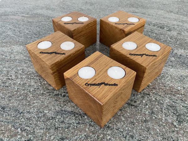 Over view of this Set of 5 Oak Cubed Block Tea-Light Candle Holders, with two tea lights in each, finished in oil, created by Crystal Woods, branded with their logo stamp