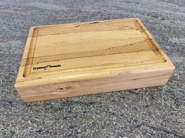 Side view of this Extra thick Spalted Beech Chopping Board with a Continuous Crumb Groove, handcrafted by Crystal Woods from locally sourced wood in Devon, finished in food safe oil, branded with their logo stamp