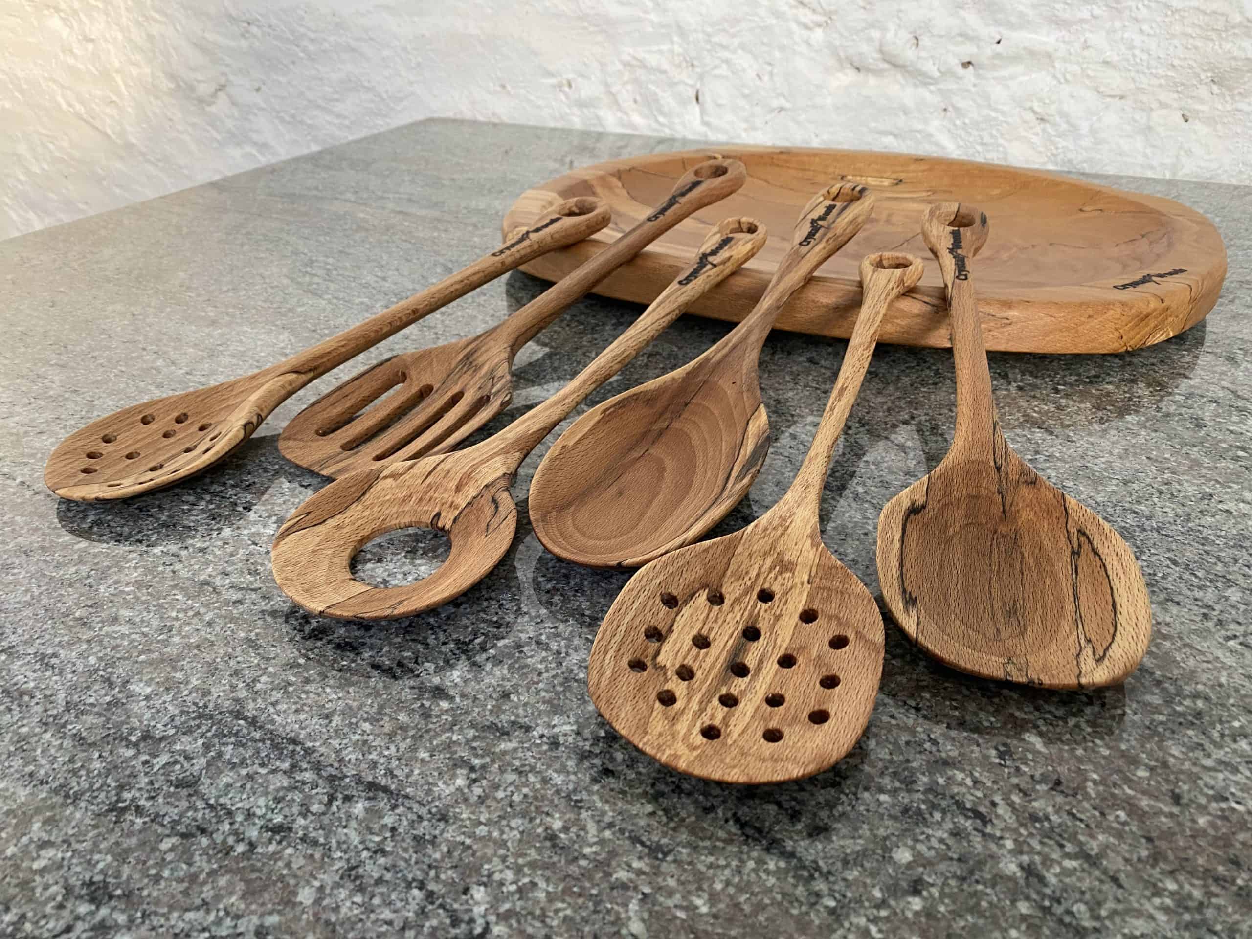 Spalted Beech Serving Spoon Set 4 Close up angled view of this Luxury Set of 6 Spalted Beech wooden serving spoons, including an egg catcher, a slotted spoon and two strainer spoons, handcrafted by Crystal Woods from locally sourced wood in Devon, finished in food safe oil