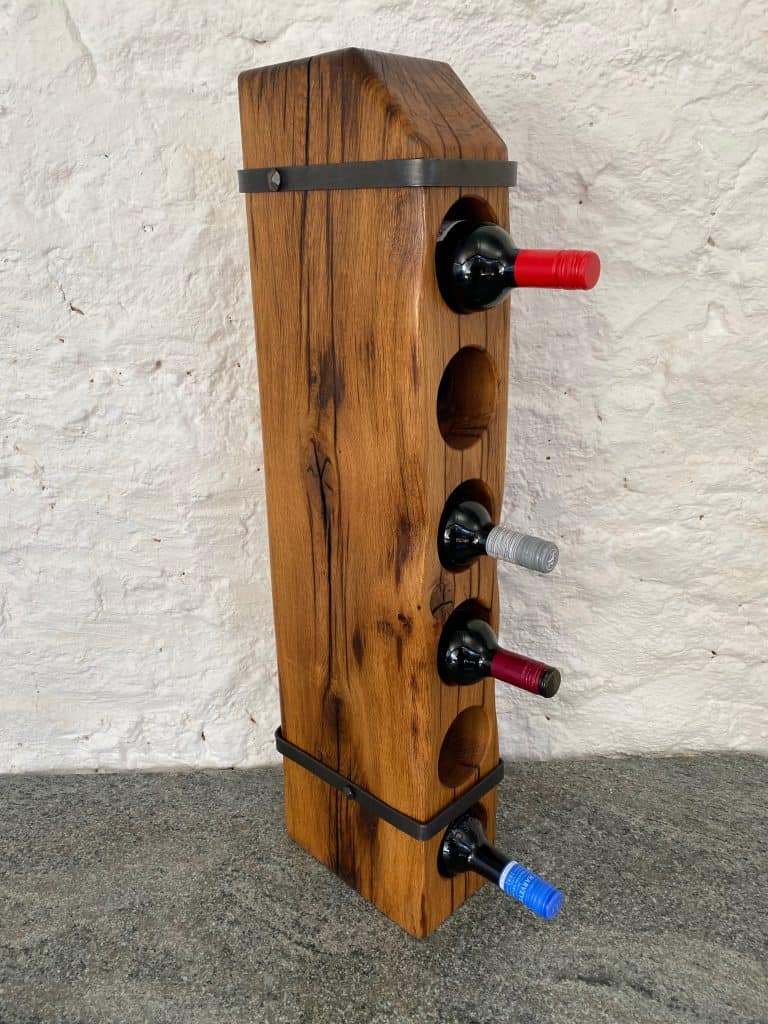 6 Bottle Railway Sleeper Wine Rack with hand forged metal straps and handmade nails, showcasing some bottles of wine