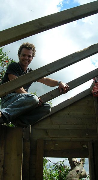 Llewie building wooden treehouse