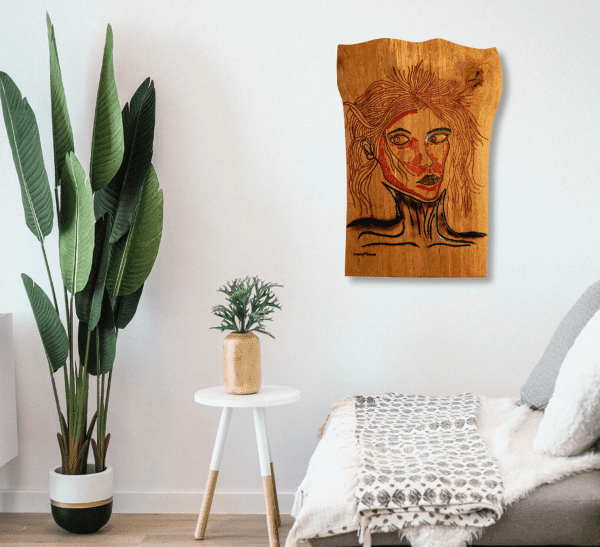 Wooden wall art of the piece titled, Victim of Fashion carved and painted onto a piece of locally sourced English Beech, created by Crystal Woods