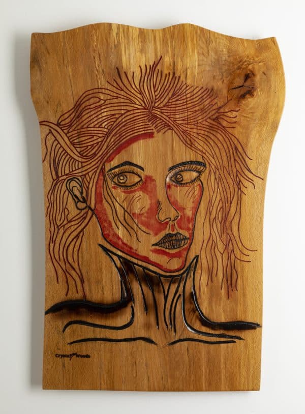 Front on view of this Wooden wall art piece titled, Victim of Fashion carved and painted onto a piece of locally sourced English Beech, created by Crystal Woods