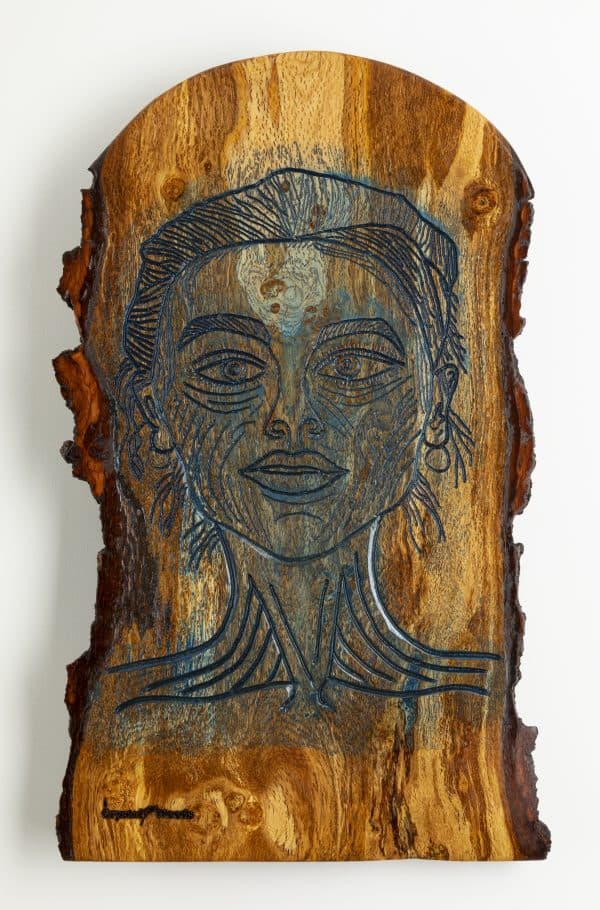 Close up view of a piece of wooden wall art titled, Mystique, carved and painted onto a live edge piece of English Oak, locally sourced in Devon, created by Crystal Woods