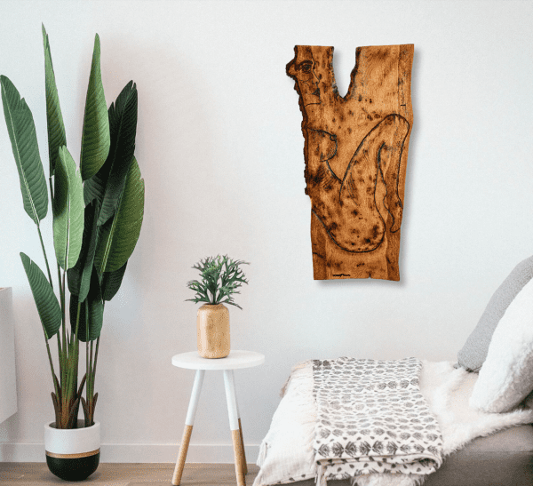 Wooden wall art of the piece titled, Mania's Connectedness shown in a lounge room setting hanging on a white wall