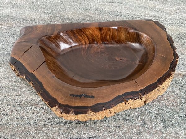 Over view of Handmade English Walnut Wooden Sculptured Reservoir Bowl with live edge detail, created by Crystal Woods, finished in danish oil, branded with their logo stamp