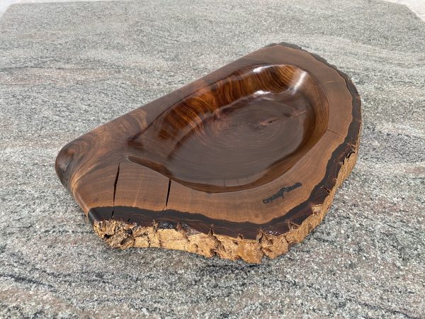 Over view shot of this Handmade English Walnut Sculptured Reservoir Bowl with live edge detail, created by Crystal Woods, finished in danish oil, branded with their logo stamp