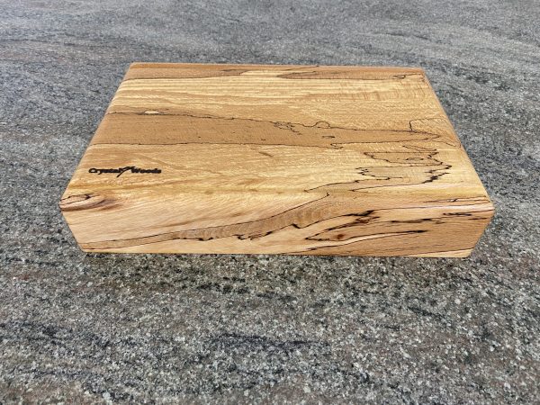 Side view of this Extra Thick chopping board made from locally sourced English Spalted Beech, with two straight flute crumb grooves, created by Crystal Woods, finished in food safe oil, branded with their logo stamp