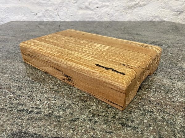 Side angle view of this Large Round Top English Spalted Beech Chopping Board, handcrafted by Crystal Woods, finished in food safe oil, locally sourced wood in Devon