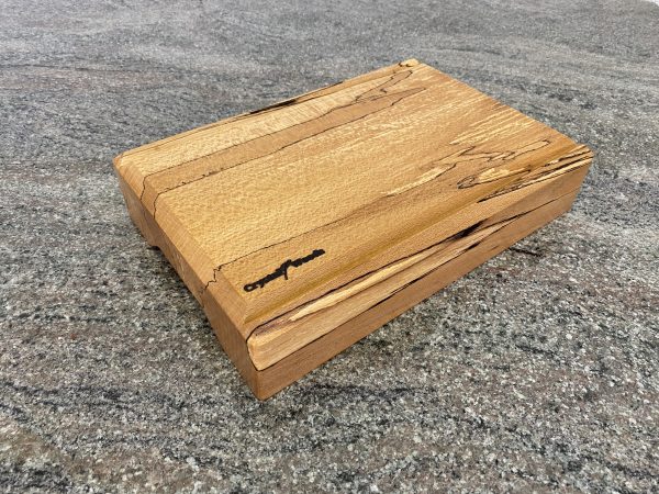 Angled side view of this Spalted Beech V-Joint Crumb Groove Chunky Chopping Board – Extra Thick, hand crafted by Crystal Woods, finished in food safe oil, branded with their logo stamp, locally sourced wood from Devon