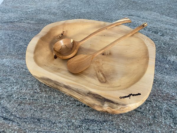 Over view of this Large Sycamore Hand Made Salad Bowl, showing a decorative wooden spoon and ladle from Spalted Beech, locally sourced wood in Devon, produced by Crystal woods and branded with their logo stamp, finished in food safe oil