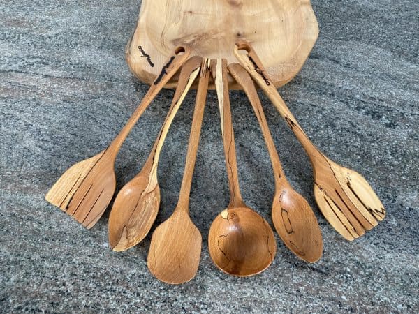 Birds eye view of this Set of 6 Beech Serving spoons with a Ladle and two slotted serving spoons, from locally sourced wood in Devon, finished in food safe oil, handcrafted by Crystal Woods