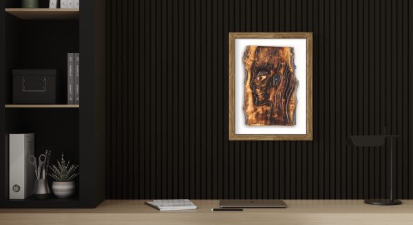 Fine Art Giclee Print of the Original Piece – The Energy Inside Me, a picture of a mans head illustrating the eternal flame of spirituality and the energy that resides within us all, shown in a natural wood frame and a white background set on a black slatted colour wall in an office study setting