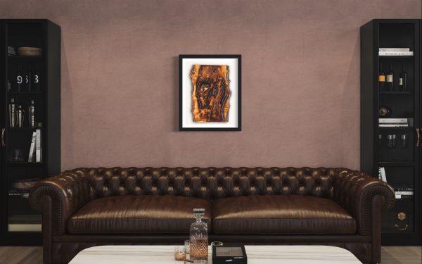 Fine Art Giclee Print of the Original Piece – The Energy Inside Me, a picture of a mans head illustrating the eternal flame of spirituality and the energy that resides within us all, shown in a black frame and a white background set on a light copper pale colour wall above a leather modern Chesterfield style sofa