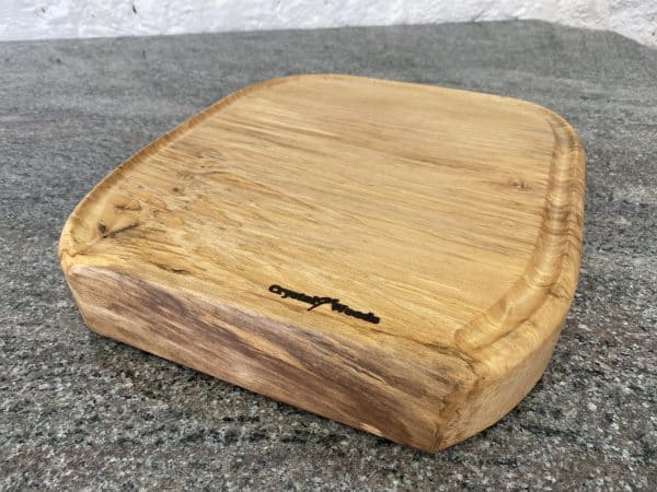 Front on close up view of this Sycamore Horseshoe Chopping Board, handcrafted by Crystal Woods, finished in food safe oil, branded with their logo stamp