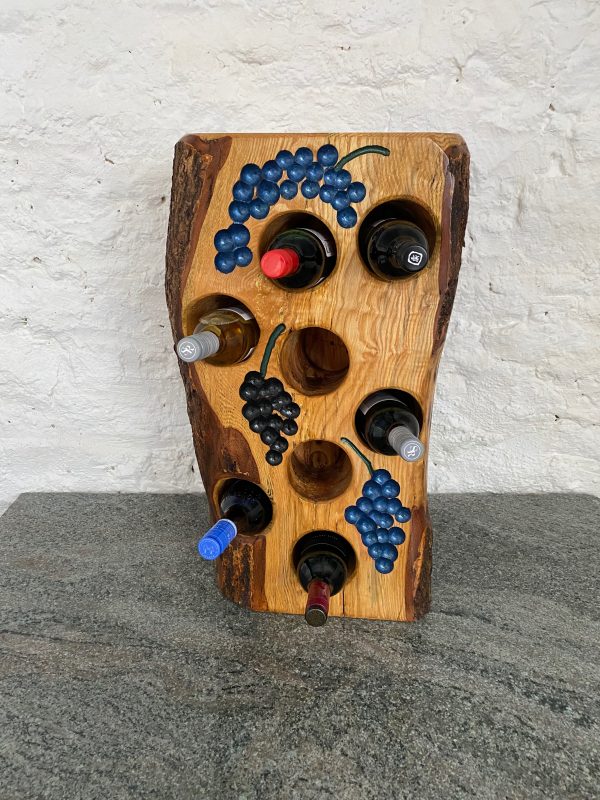 Close -up front view of an 8 bottle tree stump wine rack in English Ash with bark still attached on the sides and back