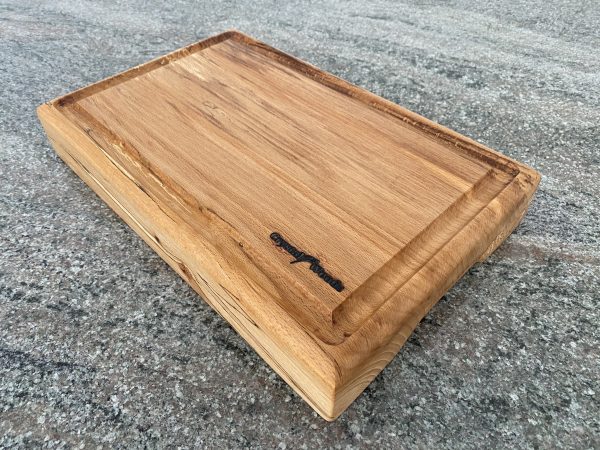 Thick slab of English Beech chopping board with crumb grooves and chamfered bottom for ease of lifting, finished in food safe oil