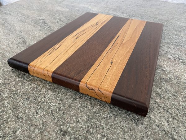 Thin and slender light weight but very durable chopping board in two contrasting colour species of African Panga Panga and English Splated Beech, finished in food safe oil