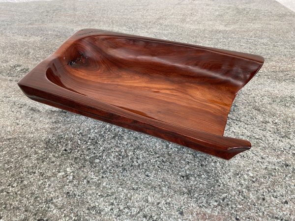 Rich texture wood grain in a hand carved open feature bowl from African Pau Rosa wood